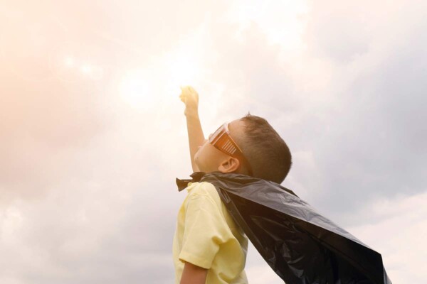 Boy reaching toward the sky